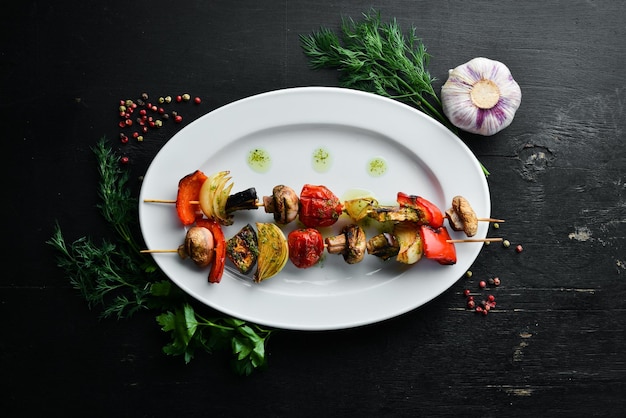 Vegetable skewers grilled vegetables mushrooms bell peppers\
tomatoes and onions