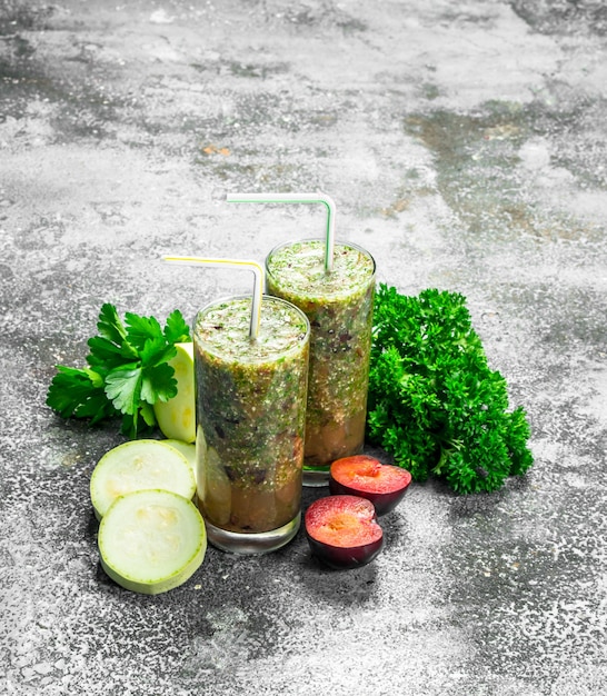 Vegetable smoothie in glasses on rustic table.