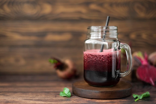 Vegetable smoothie with spinach and red beets in a glass mug