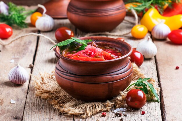 Vegetable soup in a bowl vintage wooden background rustic style selective focus
