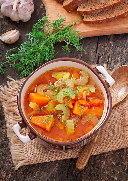 Vegetable soup on the old wooden