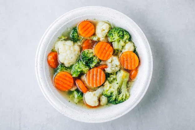 Vegetable soup spring broccoli cauliflower carrots soup in bowl