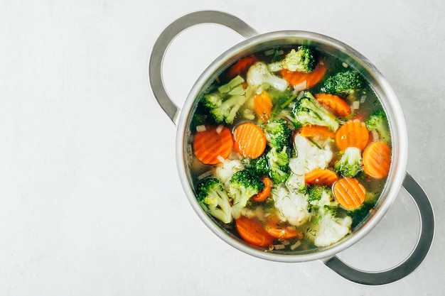 Vegetable soup Spring broccoli cauliflower carrots soup in pot