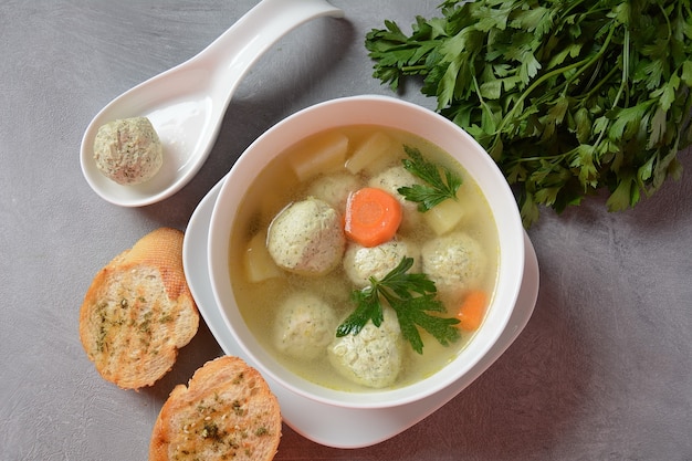 Vegetable soup with chicken meatballs in a bowl