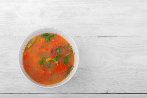 Vegetable soup with sliced carrots peppers tomatoes beans and rice