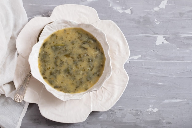 Vegetable soup with spinach in beautiful bowl