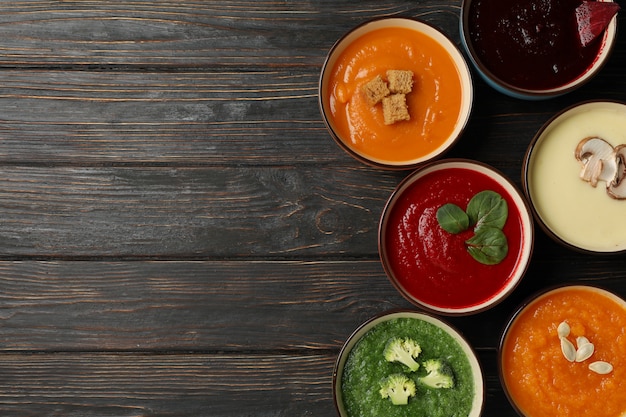 Vegetable soups on wooden, top view