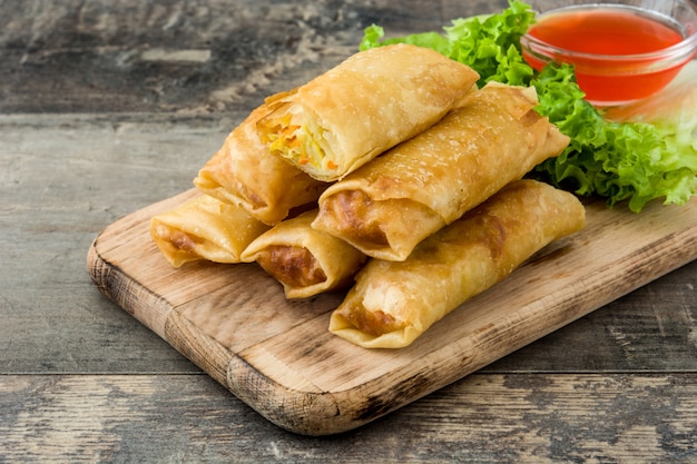 Vegetable spring roll with sauce on wooden table