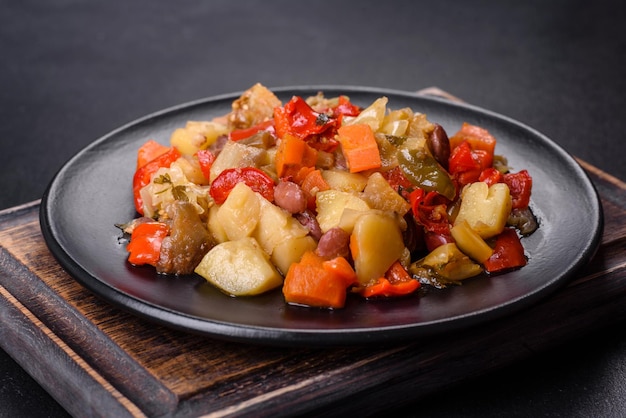 Vegetable stew or ratatouille with eggplant tomatoes sweet and hot peppers onions carrots and spices in plate