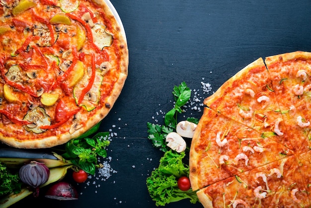 Vegetable Vegetarian Pizza On a wooden background Top view Free space for text