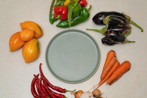 Vegetables are laid out around empty plate Empty space for text Vegetables on the table