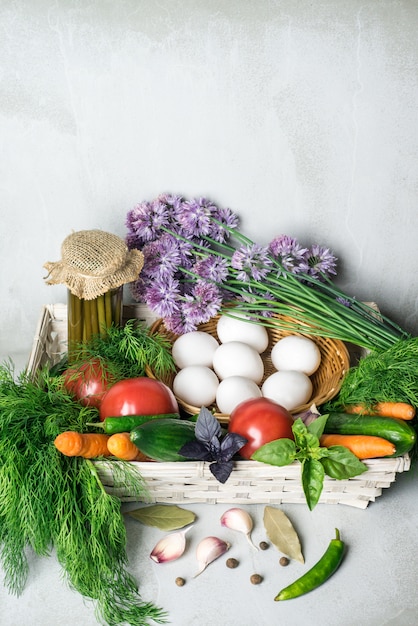 Vegetables assortment: carrot, tomatoes, cucumbers, fennel, garlic in the basket.