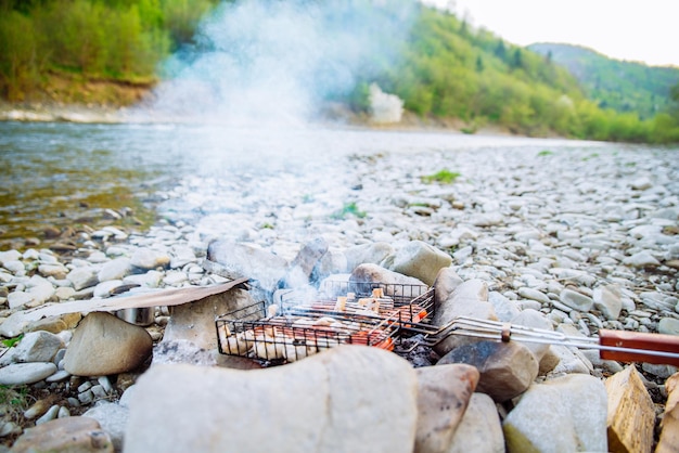 Vegetables baking on camp fire resting outside hiking concept