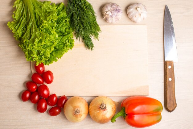 Vegetables, chopping board and knife on a table