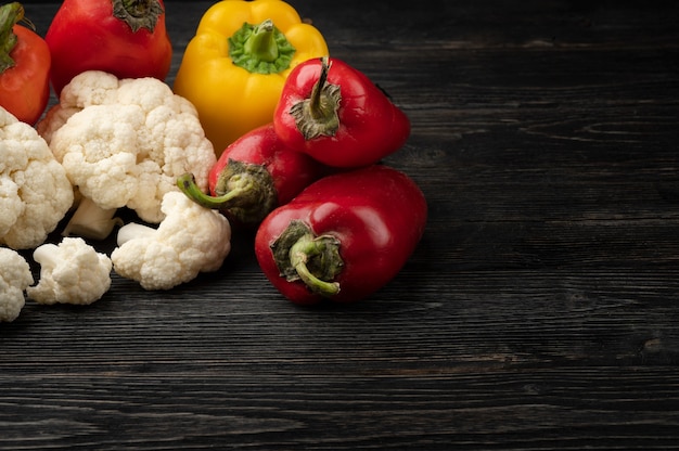 Vegetables on a dark wooden background with copy space and top view