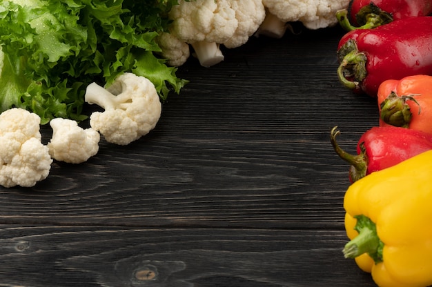 Vegetables on a dark wooden background with copy space and top view