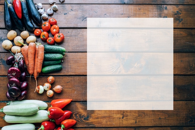 Vegetables of different colors on a dark textured background with an empty place for an inscription top view.