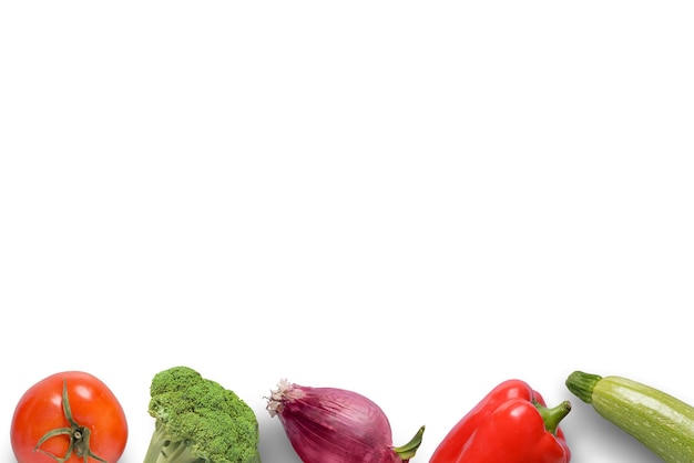 Vegetables at the footer on a white background White surface for text Top view