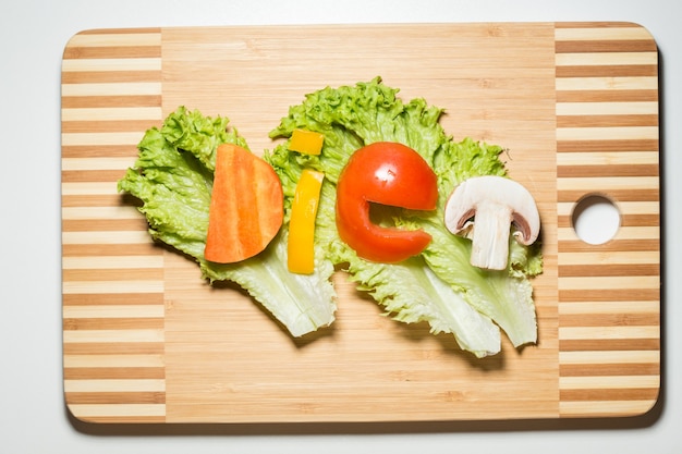 Vegetables in the form of letters on a cutting board