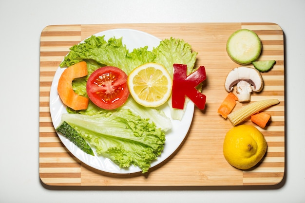 Vegetables in the form of letters on a cutting board