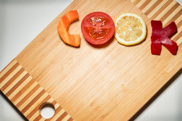 Vegetables in the form of letters on a cutting board