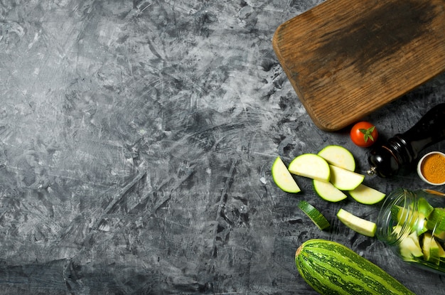 Vegetables . Fresh vegetables (cucumbers, tomatoes, onions, garlic, dill, green beans) on a gray background. Top view. copyspace