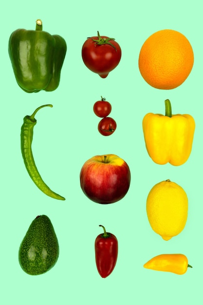 Vegetables and fruits flying on a mint background Pepper tomato avocado apple lemon orange