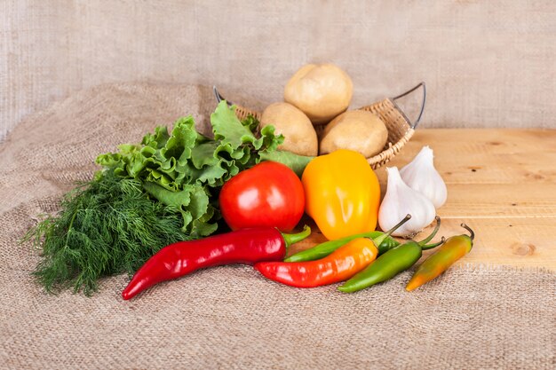 Vegetables, grains and herbs on a wooden surface