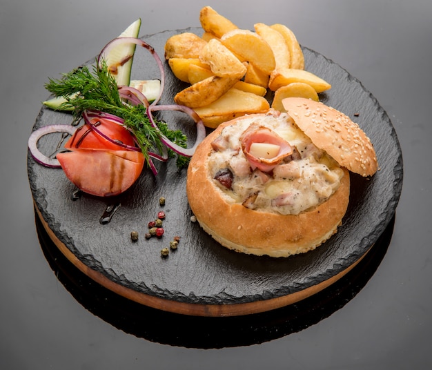 Vegetables and meat baked bun with ham, cheese and herbs