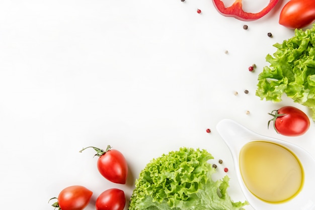 Vegetables and olive oil on a white background