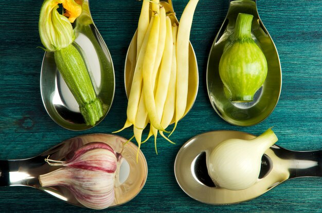 VEGETABLES ON table. FRESH VEGETABLES IN SPOONS ON A WOODEN SURFACE. COPY SPACE