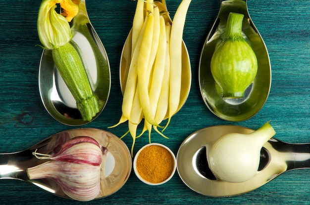 VEGETABLES ON table. FRESH VEGETABLES IN SPOONS ON A WOODEN SURFACE. COPY SPACE