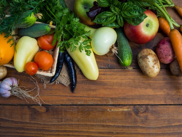 Vegetables on a wooden table. Bio Healthy food, herbs and vegetables from farm plantations.