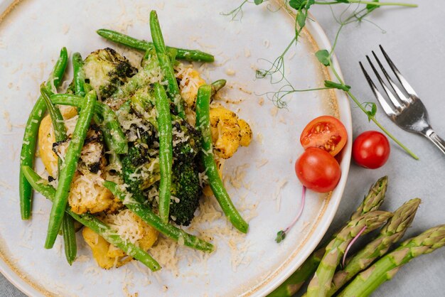 Vegetaria dish of boiled broccoli asparagus and parmesan