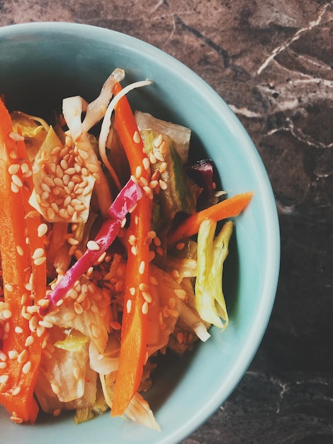 Вегетарианский азиатский овощной салат подается в миске в японском ресторане здоровой диетической пищи