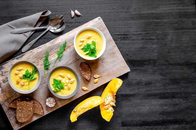 Vegetarian autumn pumpkin traditional soup with seeds creamy silky parsley dill greens crout