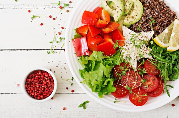 Vegetarian Buddha bowl with quinoa, tofu cheese and fresh vegetables.