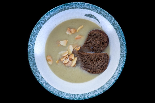 Vegetarian chestnut soup with black bread isolated for a menu