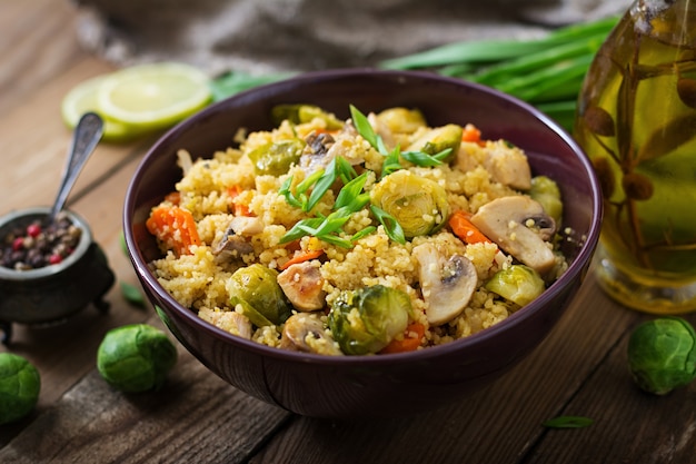 Vegetarian couscous salad with brussels sprouts, mushrooms, carrots and spices