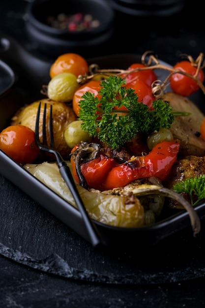 Vegetarian dish of grilled vegetables on black pan