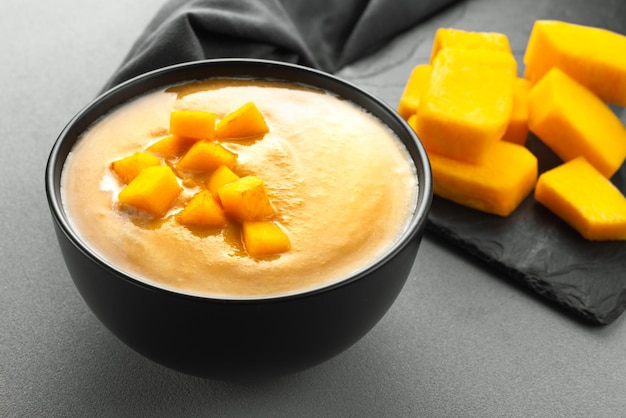 Vegetarian fall pumpkin puree soup in a black bowl  pumpkin soup