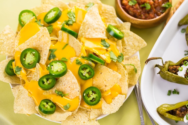 Vegetarian nachos with tortilla chips and fresh jalapeno peppers.