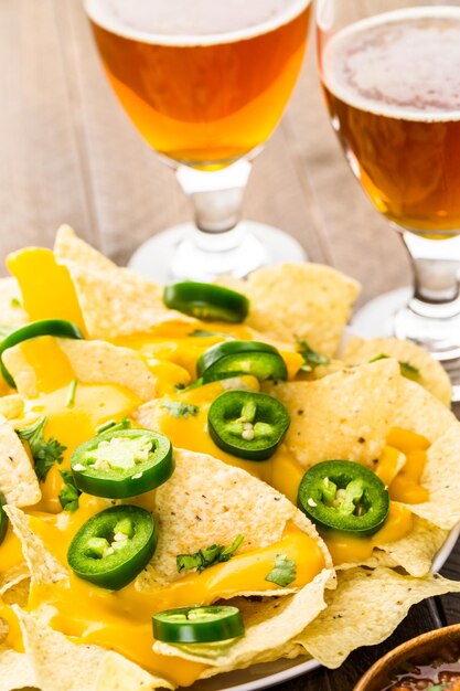 Vegetarian nachos with tortilla chips and fresh jalapeno peppers.