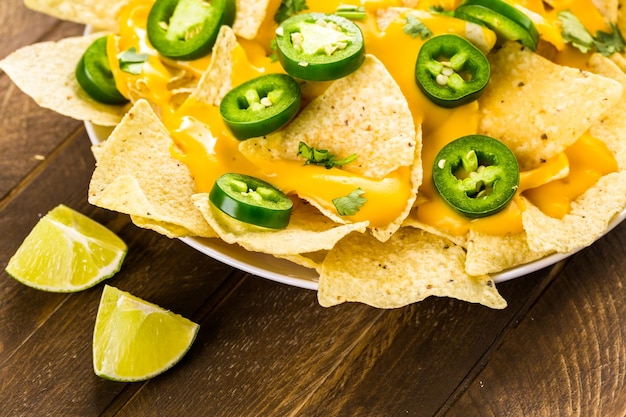 Vegetarian nachos with tortilla chips and fresh jalapeno peppers.