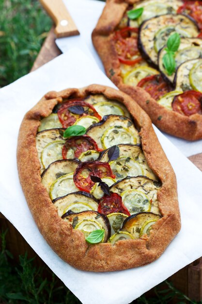 Vegetarian pies with vegetables and herbs on a stool