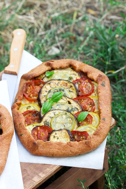 Vegetarian pies with vegetables and herbs on a stool