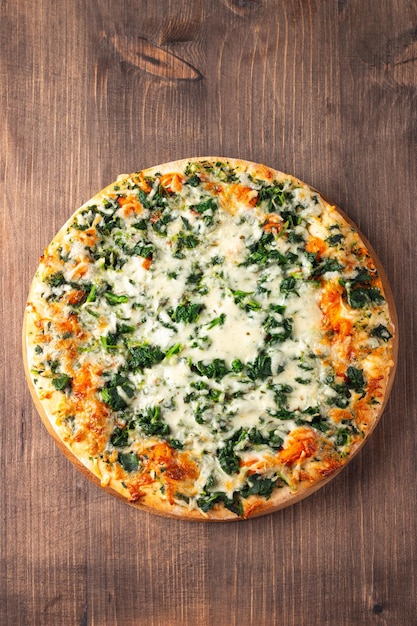 Vegetarian pizza with spinach arugula pesto cheese and parmesan Italian cuisine