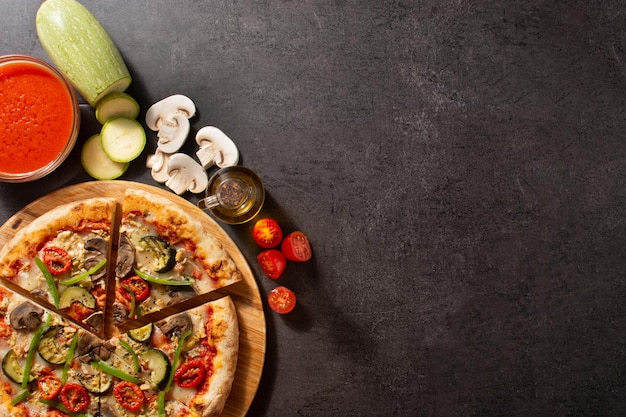 Vegetarian pizza with zucchini tomato peppers and mushrooms