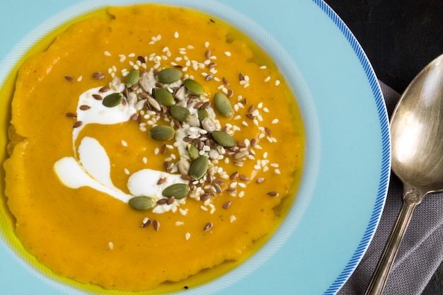 Vegetarian pumpkin cream soup on dark