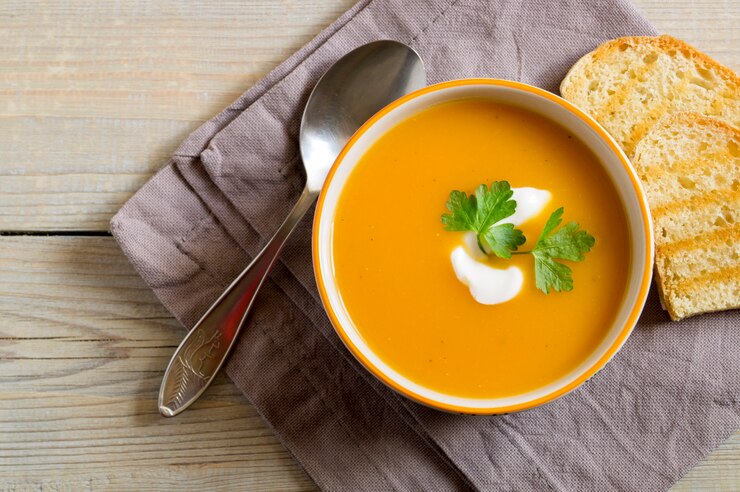 Vegetarian pumpkin soup on a wooden table.